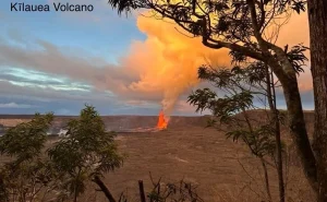 Open laptop displaying transportation blog posts list on a wooden desk
